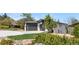 Beautifully landscaped front yard of a modern home with mature trees, lush shrubs, and a large driveway at 2665 Juilliard St, Boulder, CO 80305