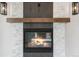 Close-up of the modern fireplace with stone accents and a sleek wooden mantle at 2665 Juilliard St, Boulder, CO 80305
