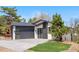 Modern home featuring a black garage door, black trim accents, and professionally landscaped front yard at 2665 Juilliard St, Boulder, CO 80305