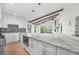 Spacious kitchen with a marble-topped island, white cabinets, and stainless steel appliances at 2665 Juilliard St, Boulder, CO 80305