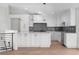 Bright kitchen features white cabinetry, gray backsplash, and marble countertops, seamlessly blending style and functionality at 2665 Juilliard St, Boulder, CO 80305