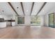 Open living room with exposed beams, an eat-in kitchen, and large windows with scenic views at 2665 Juilliard St, Boulder, CO 80305