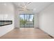 Elegant living room with modern light fixture, fireplace, and sliding glass door to the balcony at 2665 Juilliard St, Boulder, CO 80305
