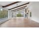 Bright living room with exposed wood beams, large windows, and a fireplace, perfect for relaxation at 2665 Juilliard St, Boulder, CO 80305