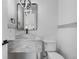 Stylish powder room featuring modern fixtures, marble countertop, and textured wall paneling at 2665 Juilliard St, Boulder, CO 80305