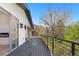 Second story deck featuring glass doors, outdoor lighting, and a black metal railing at 2665 Juilliard St, Boulder, CO 80305