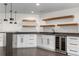 Close-up view of the wet bar featuring new cabinets, granite countertops, and a wine fridge at 2665 Juilliard St, Boulder, CO 80305