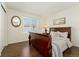 Bright bedroom with wood flooring and a comfortable sleigh bed at 8845 Jackdaw St, Littleton, CO 80126