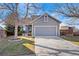 Gray two-story house with attached garage and landscaping at 8845 Jackdaw St, Littleton, CO 80126