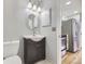 Updated bathroom with vanity, brushed nickel faucet, integrated lighting and modern fixtures at 868 S Reed Ct # H, Lakewood, CO 80226