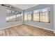 Light-filled bedroom with neutral walls and wood-look flooring, enhanced by natural light at 868 S Reed Ct # H, Lakewood, CO 80226