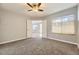 Large bedroom featuring plush carpet, double door entry, a window and neutral paint at 868 S Reed Ct # H, Lakewood, CO 80226