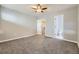 Spacious bedroom with neutral carpet, ceiling fan, closet, and ensuite bathroom access at 868 S Reed Ct # H, Lakewood, CO 80226