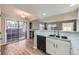 Kitchen featuring stainless steel sink, dark dishwasher, granite countertops and wood-look flooring at 868 S Reed Ct # H, Lakewood, CO 80226
