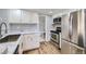 Well-lit kitchen featuring stainless steel appliances, white cabinetry and marble countertops at 868 S Reed Ct # H, Lakewood, CO 80226