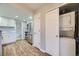 Efficient kitchenette layout with updated stainless steel appliances, cabinet storage, and adjacent laundry closet at 868 S Reed Ct # H, Lakewood, CO 80226