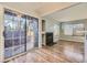 Spacious living room showcasing a sliding glass door to the patio and wood floors at 868 S Reed Ct # H, Lakewood, CO 80226