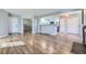 Open layout with hardwood floors, neutral paint, and a view to the kitchen and backyard at 868 S Reed Ct # H, Lakewood, CO 80226