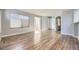 Open living space with wood floors, large windows, and access to other rooms at 868 S Reed Ct # H, Lakewood, CO 80226