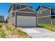 Two-car garage with white door and concrete driveway at 692 N Shawnee St, Aurora, CO 80018