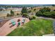 Backyard with a fire pit, Adirondack chairs, gravel area, and grassy area at 10520 W Vassar Dr, Lakewood, CO 80227