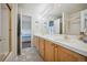 Bright bathroom with double sinks, updated vanity, and tile flooring at 10520 W Vassar Dr, Lakewood, CO 80227