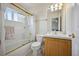 Bright bathroom features a shower/tub combo, and modern vanity at 10520 W Vassar Dr, Lakewood, CO 80227