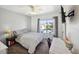 Cozy bedroom with neutral decor and a large window that offers natural light at 10520 W Vassar Dr, Lakewood, CO 80227
