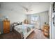 Bright bedroom with ceiling fan, large window, and ample closet space at 10520 W Vassar Dr, Lakewood, CO 80227