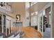 Bright foyer with hardwood floors, a staircase, and a view of the front door with stained glass at 10520 W Vassar Dr, Lakewood, CO 80227