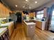 Spacious kitchen with wood floors, stainless steel appliances, and a central island with a cooktop at 10520 W Vassar Dr, Lakewood, CO 80227