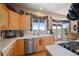 Bright kitchen with stainless steel appliances, light cabinets, and a picturesque view of the outdoors at 10520 W Vassar Dr, Lakewood, CO 80227