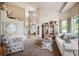 Inviting living room with high ceilings, large windows, comfortable seating, and a cozy atmosphere at 10520 W Vassar Dr, Lakewood, CO 80227