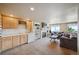 Spacious living room with a wet bar, fireplace, and large windows showcasing scenic views at 10520 W Vassar Dr, Lakewood, CO 80227