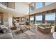 Bright and airy living room featuring large windows, comfortable seating, and access to the kitchen area at 10520 W Vassar Dr, Lakewood, CO 80227