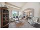 Comfortable living room with a view to the dining room, large window, and stylish furniture at 10520 W Vassar Dr, Lakewood, CO 80227