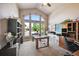 Spacious office with ample natural light from large windows and built-in shelving and storage at 10520 W Vassar Dr, Lakewood, CO 80227