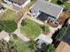Aerial view of the backyard featuring a lush green lawn, patio, storage shed, and privacy fence at 4740 W Wyoming Pl, Denver, CO 80219