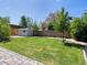 Lush backyard with a shed, green lawn, and a well-maintained fence at 4740 W Wyoming Pl, Denver, CO 80219