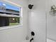 Bright bathroom with subway tile, modern fixtures, and view of the backyard at 4740 W Wyoming Pl, Denver, CO 80219