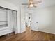 Sunny bedroom featuring wood floors, closet, and ceiling fan at 4740 W Wyoming Pl, Denver, CO 80219