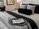 Cozy bedroom detail showcasing decorative pillows, a tray with glasses, and soft bedding at 4740 W Wyoming Pl, Denver, CO 80219