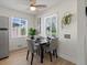Cozy dining area with a stylish table setting, a modern ceiling fan, and bright natural light at 4740 W Wyoming Pl, Denver, CO 80219