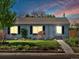 Charming single-story home with green lawn and garden under a bright sky with hints of pink at dusk at 4740 W Wyoming Pl, Denver, CO 80219