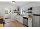 Modern kitchen with white cabinets, butcher block countertops, stainless steel appliances, and open shelving at 4740 W Wyoming Pl, Denver, CO 80219