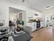 Open concept view of the kitchen with dining area and living room with hardwood floors at 4740 W Wyoming Pl, Denver, CO 80219
