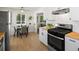 Eat-in kitchen featuring stainless steel appliances, butcher block countertops, and a sun-filled dining area at 4740 W Wyoming Pl, Denver, CO 80219