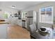 Bright kitchen featuring a stainless steel refrigerator, white cabinets, and butcher block countertops at 4740 W Wyoming Pl, Denver, CO 80219