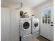 Bright laundry room featuring a folding screen, modern machines and access to the backyard at 4740 W Wyoming Pl, Denver, CO 80219