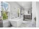 Bright bathroom featuring a luxurious soaking tub, marble accents, and dual windows at 501 S Race St, Denver, CO 80209